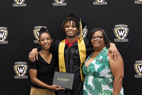 Graduate surrounded by two women